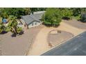 Aerial view of a single-Gathering home featuring mature trees and a gravel yard at 3964 S Turquoise Dr, Buckeye, AZ 85326