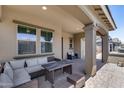 Covered patio with wicker furniture, perfect for outdoor entertaining at 41650 W Barcelona Dr, Maricopa, AZ 85138