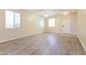 Spacious living room featuring vinyl floors, a ceiling fan, and plenty of natural light at 42564 W Palmyra Ln, Maricopa, AZ 85138