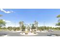 Community entrance with beautiful landscaping and stone accents at 44092 W Stonecreek Rd, Maricopa, AZ 85139