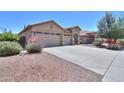 Charming single-Gathering home with a three-car garage and desert landscaping at 44092 W Stonecreek Rd, Maricopa, AZ 85139