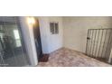 Enclosed front patio featuring tile flooring and secure metal gate at 4733 W Eva St, Glendale, AZ 85302
