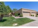 Tan exterior elevation with lush green lawn and desert landscaping at 5505 E Mclellan Rd # 111, Mesa, AZ 85205
