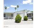 Charming home with desert landscaping, covered porch, and a white picket fence at 5808 E Lockwood St, Mesa, AZ 85215