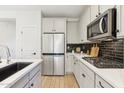 Updated kitchen with white countertops, modern appliances and sleek cabinetry at 6641 N Desert Shadow Ln, Phoenix, AZ 85014