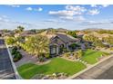 Captivating single-Gathering home in a serene neighborhood, boasting a lush lawn and meticulously maintained landscaping at 6918 E Ivyglen St, Mesa, AZ 85207