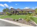 Inviting single-Gathering home with meticulous landscaping and a well-manicured lawn at 6918 E Ivyglen St, Mesa, AZ 85207