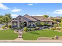 Beautiful single-Gathering home with lush front yard and stone facade at 6918 E Ivyglen St, Mesa, AZ 85207