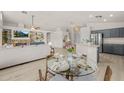 Dining area features a glass table, seating for four, and seamless flow into the kitchen and living room at 7701 E Portobello Ave, Mesa, AZ 85212