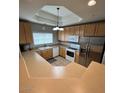 Well-lit kitchen with stainless steel appliances and ample counter space for meal preparation at 8245 E Bell Rd # 103, Scottsdale, AZ 85260