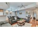 Inviting living room featuring wood floors, neutral paint and comfortable seating arrangements at 8245 E Bell Rd # 103, Scottsdale, AZ 85260
