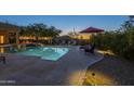 Inviting backyard pool featuring desert landscaping, lounge seating and mountain views at 8248 E Arroyo Hondo Rd, Scottsdale, AZ 85266
