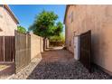 Gated side yard with stone landscaping providing access to a private outdoor space at 8555 W Purdue Ave, Peoria, AZ 85345