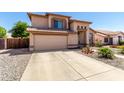 Inviting home exterior showcasing a spacious driveway, well-kept garden, and a classic design at 8555 W Purdue Ave, Peoria, AZ 85345