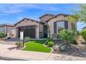 Charming one-story home featuring a lush, green front lawn and well-maintained landscaping at 93 E Santa Lucia Ln, Queen Creek, AZ 85140