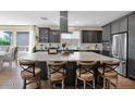 Elegant kitchen featuring a large island, stainless steel appliances, and modern finishes at 93 E Santa Lucia Ln, Queen Creek, AZ 85140