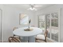 Bright dining area featuring a round table, stylish chairs, and sliding doors to the patio at 9805 W Gulf Hills Dr, Sun City, AZ 85351