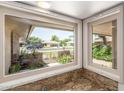 Bright window view showcasing the neighborhood and charming front yard at 9805 W Gulf Hills Dr, Sun City, AZ 85351