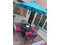 Enclosed patio with tile flooring, umbrella, and comfortable seating at 1001 N Pasadena St # 162, Mesa, AZ 85201