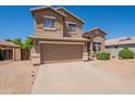 Charming two-story home with an attached two-car garage and low maintenance landscaping at 10228 E Carol Ave, Mesa, AZ 85208