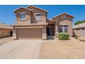 Inviting two-story home with attached garage and low maintenance rock landscaping at 10228 E Carol Ave, Mesa, AZ 85208