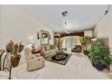 Cozy living room featuring high ceilings, a ceiling fan and ample natural light at 10347 W Mohawk Ln, Peoria, AZ 85382