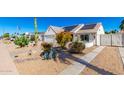 Attractive single-story home boasting desert landscaping, solar panels, and a well-maintained yard at 1042 E Utopia Rd, Phoenix, AZ 85024