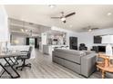 Open-concept living space with a modern gray couch and views into the kitchen at 1042 E Utopia Rd, Phoenix, AZ 85024