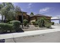 Beautiful single-story home with desert landscaping, mature trees, and a welcoming front entrance at 1123 E Shepherds Way, Casa Grande, AZ 85122