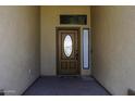 Elegant front entry featuring a decorative glass door, sidelight, and stylish welcome mat at 1123 E Shepherds Way, Casa Grande, AZ 85122