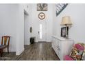 Inviting home entrance featuring light-filled space, wood floors, and decorative accents at 1221 E Paseo Way, Phoenix, AZ 85042