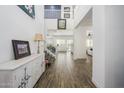 Bright, open foyer with soaring ceilings, elegant staircase, and wood-look tile flooring at 1221 E Paseo Way, Phoenix, AZ 85042