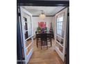 Cozy dining room featuring a chandelier, floral painting, and hardwood floors at 1222 E Almeria Rd, Phoenix, AZ 85006