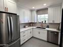 Modern kitchen featuring stainless steel appliances, white cabinetry, and a stylish backsplash at 1222 E Almeria Rd, Phoenix, AZ 85006