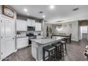 Open concept kitchen with island seating flows into the dining area, perfect for entertaining guests at 13657 W Paso Trl, Peoria, AZ 85383