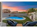 Relaxing backyard with a sparkling pool, comfortable lounge chairs, and desert views at 1414 E Cathedral Rock Dr, Phoenix, AZ 85048