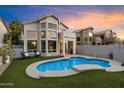 Beautiful backyard features a refreshing pool, lush green lawn, and great patio space at 1414 E Cathedral Rock Dr, Phoenix, AZ 85048