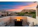 Relaxing patio area with comfortable seating and a cozy fire pit with mountain views at 1414 E Cathedral Rock Dr, Phoenix, AZ 85048