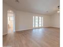 Bright living area with new luxury vinyl flooring, french doors, and seamless flow to other living spaces at 14771 W Columbus Ave, Goodyear, AZ 85395