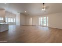 Spacious open-concept living room featuring luxury vinyl flooring and french doors leading outside at 14771 W Columbus Ave, Goodyear, AZ 85395