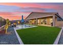 Expansive backyard with a pool, lush turf, and a covered patio for seamless indoor-outdoor living at 16417 W Fawn Dr, Goodyear, AZ 85338