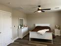 Cozy bedroom featuring a ceiling fan, a white bed frame, and light, neutral-colored walls at 17344 W Adams St, Goodyear, AZ 85338