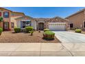 Charming single-story home with a stone accent facade, low-maintenance landscaping, and a two-car garage at 18041 W Ivy Ln, Surprise, AZ 85388