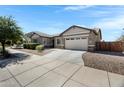 Lovely single-Gathering home featuring desert landscaping and an extended concrete driveway at 19009 E Reins Rd, Queen Creek, AZ 85142
