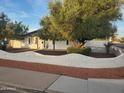 Charming home with white brick retaining wall and lush trees, adding to its curb appeal at 1922 N 21St Pl, Phoenix, AZ 85006