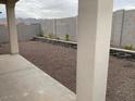 View of a low maintenance backyard with decorative rock and retaining walls at 20346 W Sells Dr, Buckeye, AZ 85396
