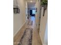 Inviting hallway featuring wood-look tile flooring and access to various rooms of the home at 20346 W Sells Dr, Buckeye, AZ 85396