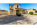 The side exterior showcases the desert landscaping surrounding the charming two-story home at 21538 E Alyssa Ct, Queen Creek, AZ 85142