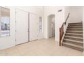 Bright foyer featuring tile flooring, a staircase, and a view into the home at 21538 E Alyssa Ct, Queen Creek, AZ 85142