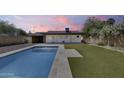 Beautiful pool surrounded by green grass, perfect for entertaining or relaxing in the sun at 2336 E Flower St, Phoenix, AZ 85016